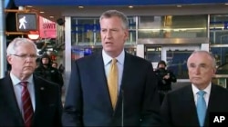 In this photo provided by WNYW Fox 5 NY, New York Mayor Bill de Blasio speaks during a news conference in New York's Times Square, Wednesday, Nov. 18, 2015.