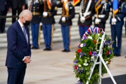 President Joe Biden stands during a wreath laying ceremony to commemorate Veterans Day and mark the centennial anniversary of the Tomb of the Unknown Soldier at Arlington National Cemetery, in Arlington, Va., Nov. 11, 2021.