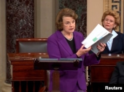 Senate Intelligence Committee Chairwoman Dianne Feinstein (D-CA) (L) discusses a newly released Intelligence Committee report on the CIA's anti-terrorism tactics, in a speech on the floor of the U.S. Senate, Capitol Hill, De. 9, 2014.