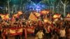 Pro unity demonstrators wave Spanish and Catalan flags during a protest after the Catalan regional parliament declared independence from Spain in Barcelona, Spain, Oct. 27, 2017. 