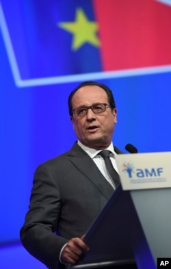 French President Francois Hollande delivers a speech during a meeting with French mayors in Paris, Nov. 18, 2015.