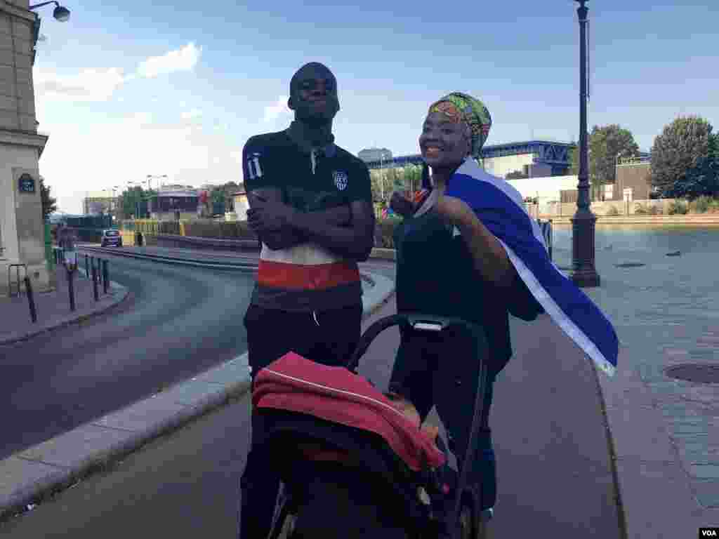 Fatoumata Kebe walks with a friend and her baby after the match, in Paris, France, July 15, 2018. (L. Bryant/VOA)