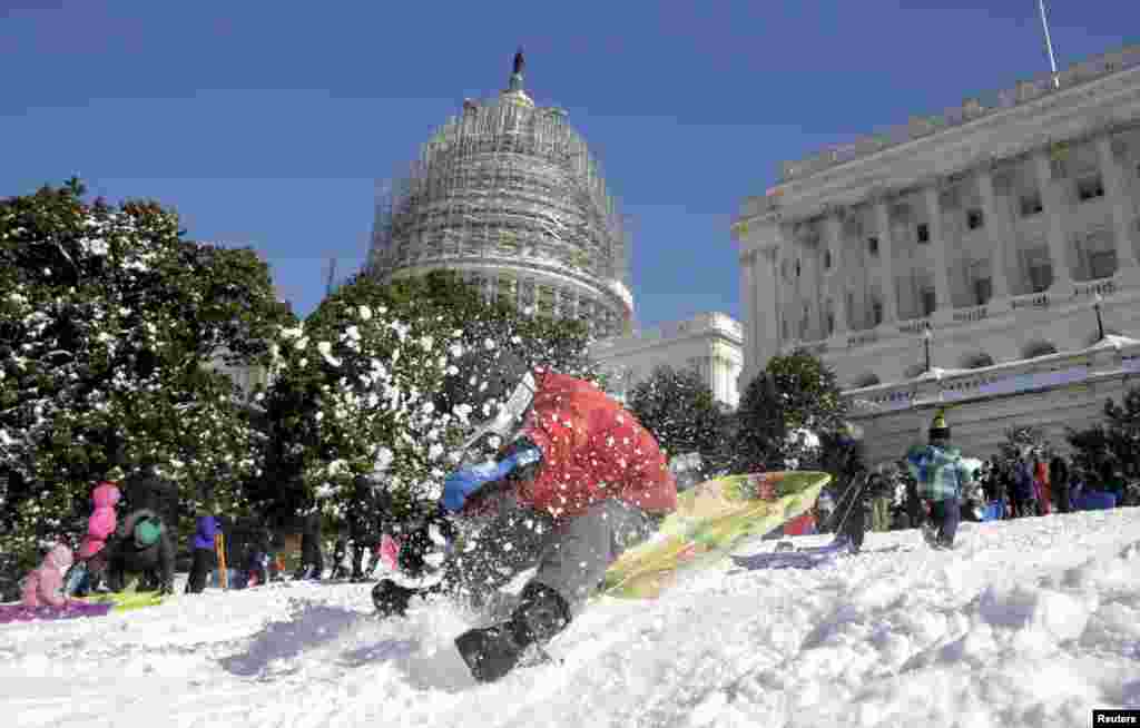 A boy crashes his sled on a hill at the U.S. Capitol after a major winter storm swept over Washington, D.C.&nbsp;&nbsp;The National Weather Service said 17.8 inches (45.2 cm) fell in Washington, tying as the fourth-largest snowfall in the city&#39;s history.&nbsp;