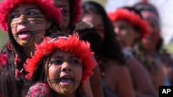 Brazilian Pataxo women take part in a ritual dance during a protest against a proposed constitutional amendment that would put demarcation of indigenous lands into the hands of the Congress, in front of Brazil’s National Congress, in Brasilia, Nov. 10, 2015.