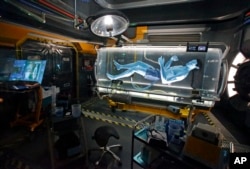 In this April 29, 2017 photo, park guests see a Na'vi in a science lab while in the queue for the Avatar Flight of Passage ride at Pandora-World of Avatar land attraction in Disney's Animal Kingdom theme park at Walt Disney World in Lake Buena Vista, Florida.