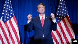 Virginia Gov.-elect Glenn Youngkin arrives to speak at an election night party in Chantilly, Va., Nov. 3, 2021, after he defeated Democrat Terry McAuliffe. 