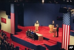 FILE - Presidential candidates, from left, Ross Perot, Bill Clinton, and President George Bush, participate in the first presidential debate in St. Louis, Mo., Oct. 12, 1992.