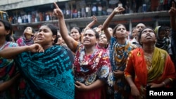 Garment workers shout as they call on other workers to join them during a protest in Dhaka September 23, 2013.