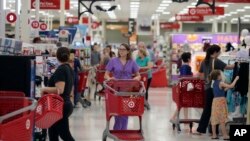 FILE - Shoppers make their way through a Target store in Dallas, Texas, Oct. 13, 2017.