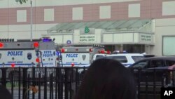 In this image taken from video, emergency personnel converge on Bronx Lebanon Hospital in New York, after a gunman opened fire there, June 30, 2017.