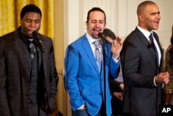 FILE - Actor Okieriete Onaodowan, left, actor Lin-Manuel Miranda and actor Christopher Jackson perform the song "Alexander Hamilton" from the Broadway play "Hamilton" in the East Room of the White House in Washington, March 14, 2016.