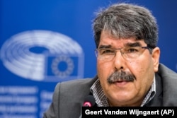 FILE - Salih Muslim addresses the media on the situation in Syria, the war against Islamic State and the urgent humanitarian needs of the civilian population, at the European Parliament.