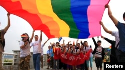 Activists march during a demonstration to mark the International Day Against Homophobia and Transphobia in Changsha, May 17, 2013. The banner reads, "Homosexsuals are also ordinary people". 