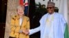 British Prime Minister Theresa May, left, is welcomed by Nigeria's President Muhammadu Buhari, at the Presidential palace in Abuja, Nigeria, Aug. 29, 2018.