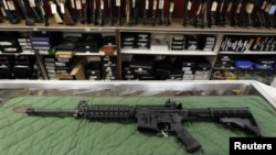 FILE - AR-15 style rifle is displayed at the Firing-Line indoor range and gun shop, in Aurora, Colorado.