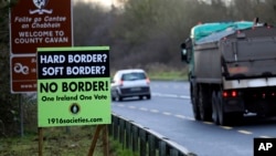 A poster against a hard border stands on the border between Northern Ireland and the Republic of Ireland near the town of Derrylin, Northern Ireland, Dec. 12, 2018. 