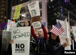 People protest outside before former Starbucks CEO Howard Schultz speaks during his book tour in Seattle, Jan. 31, 2019.