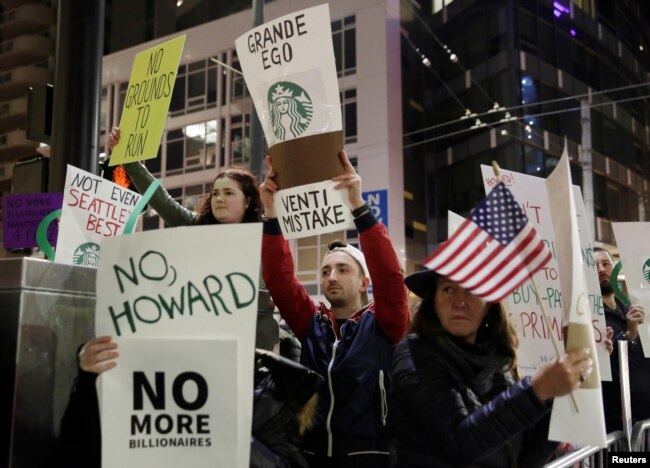 People protest outside before former Starbucks CEO Howard Schultz speaks during his book tour in Seattle, Jan. 31, 2019.