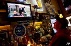 Robbo Coleman watches a live broadcast of former President Barack Obama waving goodbye during the inauguration of President Donald Trump at the Sawmill Saloon in Prairie du Chien, Wis., Jan. 20, 2017.