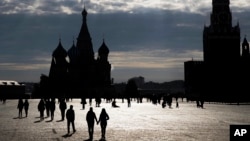FILE - People walk through Red Square in Moscow.