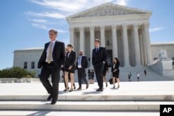 People leave the Supreme Court in Washington, June 26, 2017, as justices issued their final rulings for the term.