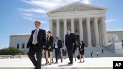 People leave the Supreme Court in Washington, June 26, 2017.