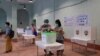 A woman wearing a protective face masks casts her ballot for the general election at a polling station in Yangon, Myanmar, November 8, 2020.?REUTERS/Shwe Paw Mya Tin