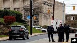 First responders stand outside the Tree of Life Synagogue in Pittsburgh, where a shooter opened fire, Oct. 27, 2018, injuring multiple people, including police officers. 