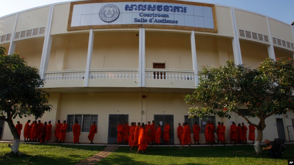 Cambodian Buddhist wait outside the court hall before they attending the hearings against two former Khmer Rouge senior leaders, at the U.N.-backed war crimes tribunal on the outskirts of Phnom Penh, Cambodia, Friday, Nov. 16, 2018. 