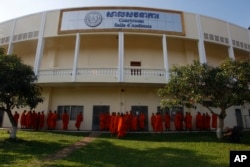 FILE - Cambodian Buddhist wait outside the court hall before they attending the hearings against two former Khmer Rouge senior leaders, at the U.N.-backed war crimes tribunal on the outskirts of Phnom Penh, Cambodia, Friday, Nov. 16, 2018
