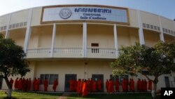 FILE - Cambodian Buddhist wait outside the court hall before they attending the hearings against two former Khmer Rouge senior leaders, at the U.N.-backed war crimes tribunal on the outskirts of Phnom Penh, Cambodia, Friday, Nov. 16, 2018. 