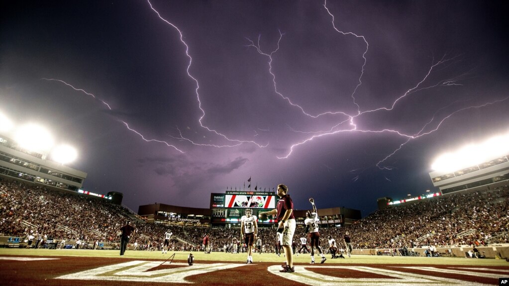 After an hour long weather delay, a lightning strike occurs as Texas State warms up in Doak Campbell Stadium prior to an NCAA college football game against Florida State in Tallahassee, Fla., Saturday, Sept. 5, 2015. (AP Photo/Mark Wallheiser)