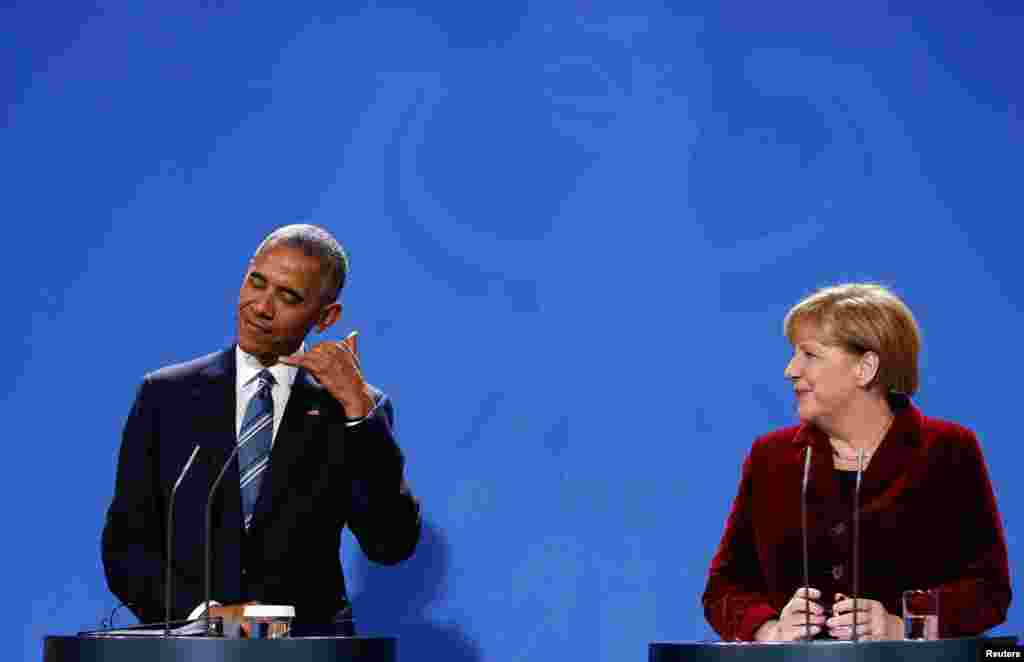 U.S. President Barack Obama gestures during a joint news conference with German Chancellor Angela Merkel in Berlin.