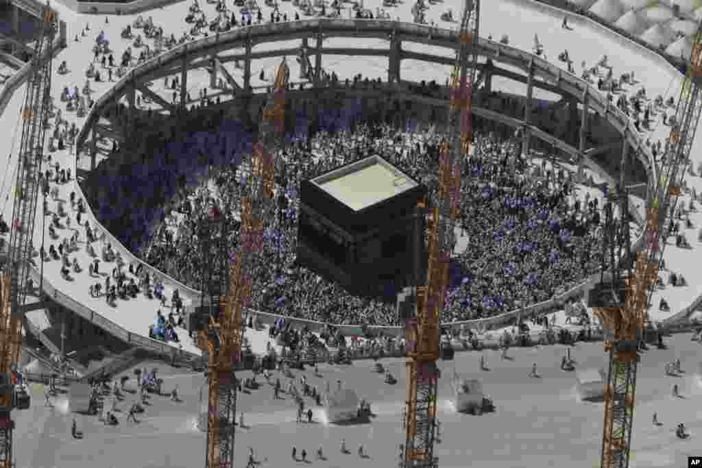 Cranes rise at the site of an expansion to the Grand Mosque as Muslim pilgrims circle counterclockwise around the Kaaba at the Grand Mosque in Mecca, Saudi Arabia, Oct. 16, 2013.