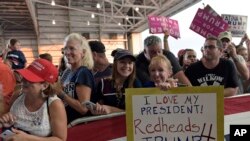 People wait to hear President Donald Trump speak at his "Make America Great Again Rally" at Orlando-Melbourne International Airport in Melbourne, Fla., Feb. 18, 2017.