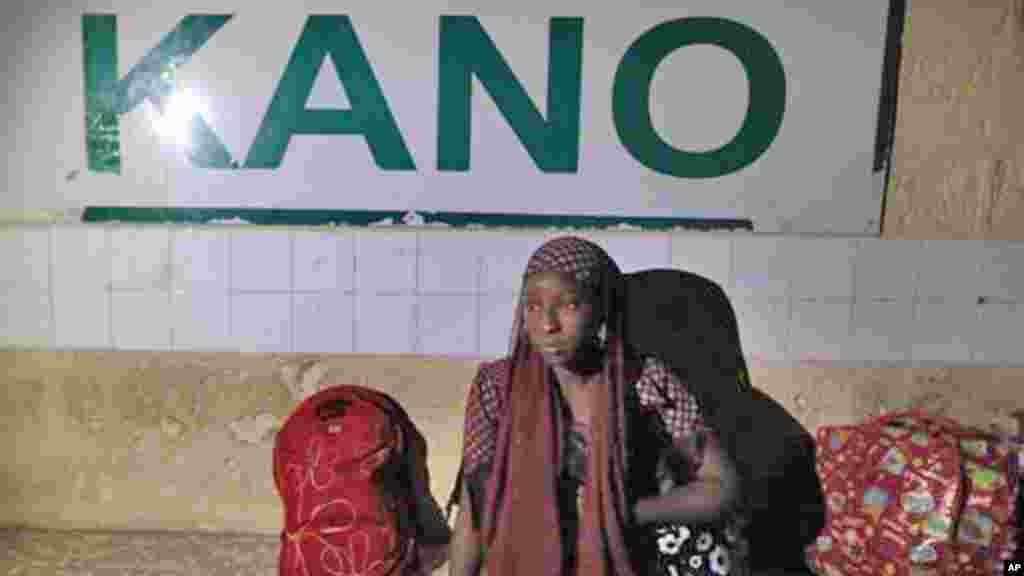 A passenger waits for an Ooni of Ife train to arrive in Kano, Nigeria.
