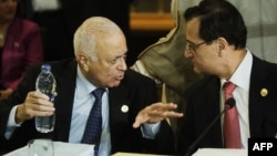 Arab League Secretary General Nabil al-Arabi (L) and Lebanese Foreign Affairs Minister Adnan Mansur (R) talk during the opening session of the Arab foreign minister meeting in Cairo, March 6, 2013.