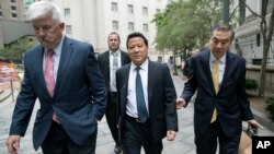 Ng Lap Seng, center, leaves federal court in Manhattan, July 27, 2017.