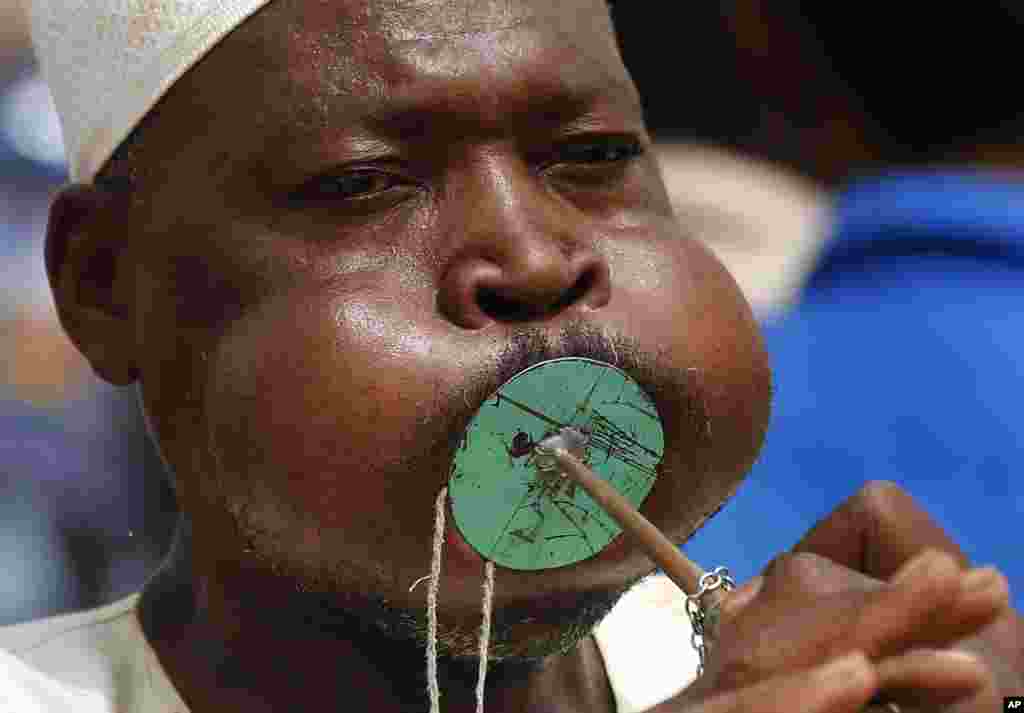 A Sudanese supporter of Gen. Mohammed Hamdan Dagalo, the deputy head of the military council, better known as Hemedti, blows a horn during a military-backed rally, in Mayo district, south of Khartoum, June 29, 2019.