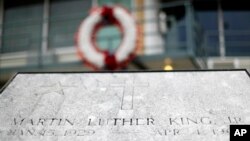 FILE - The balcony where the Rev. Martin Luther King Jr. was killed on April 4, 1968, stands above a plaque on Martin Luther King Jr. Day, in Memphis, Tenn.,Jan. 16, 2017. Residents of Memphis are honoring King's legacy with neighborhood clean-up events and a daylong celebration at the National Civil Rights Museum. 