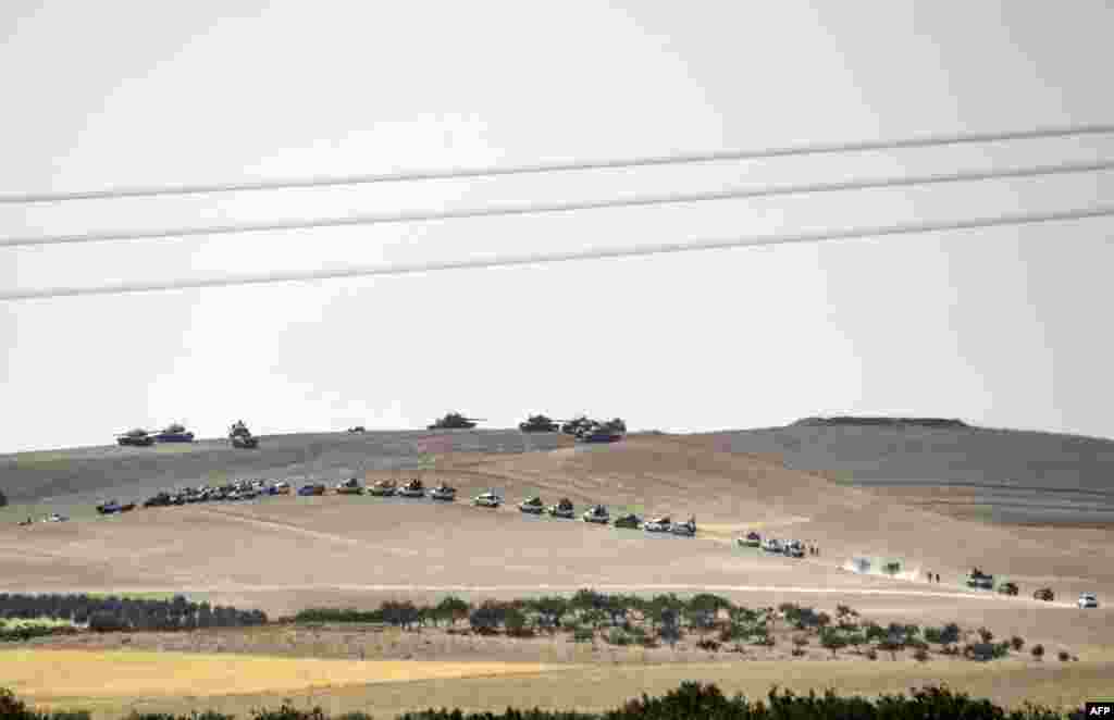 This picture taken from the Turkish Syrian border city of Karkamis in the southern region of Gaziantep, shows Turkish army tanks and pro-Ankara Syrian opposition fighters moving two kilometers west from the Syrian Turkish border town of Jarabulus. Turkey&#39;s army backed by international coalition air strikes launched an operation to drive Islamic State jihadists out of a key Syrian border town.