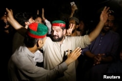 Supporters of Imran Khan, chairman of Pakistan Tehreek-i-Insaf (PTI) gesture to celebrate after Khan was elected as Prime Minister, in Peshawar, Pakistan, Aug. 17, 2018.