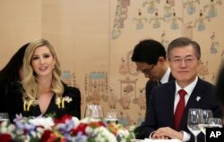 In this photo provided by South Korea Presidential Blue House, Ivanka Trump, the daughter of U.S. President Donald Trump, and South Korean President Moon Jae-in, right, attend a dinner at the presidential Blue House in Seoul, South Korea, Feb. 23, 2018.