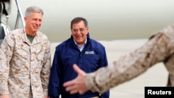 In this file photo, Lt. General Thomas Waldhauser, left, of 1st Marine Expeditionary Force greets then-U.S. Secretary of Defense Leon Panetta upon his arrival at Camp Pendleton, Calif., March 30, 2012.