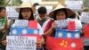 Filipino student activists hold mock Chinese ships to protest recent island-building and alleged militarization by China off the disputed Spratlys group of islands in the South China Sea during a rally near the Malacanang presidential palace in Manila, Ph