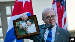U.S. Democratic congressman for the state of Massachusetts and House Rules Committee Chairman Rep. Jim McGovern holds up a framed archival image that shows him and Fidel Castro, during the inauguration of a conservation center in Havana, Cuba, March 30, 2019.