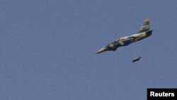 A Syrian Air Force fighter jet launches missiles at El Edaa district in Syria's northwestern city of Aleppo, September 1, 2012.
