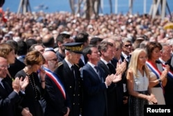 French Prime Minister Manuel Valls (C), President of the Provence Alpes Cote d'Azur (PACA) region Christian Estrosi and Prince Albert II of Monaco stand at the Monument du Centenaire during a minute of silence on the third day of national mourning to pay