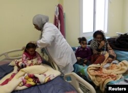 FILE - Children, who Libyan forces said left the last cluster of buildings controlled by Islamic State in the group's former stronghold of Sirte, receive medical treatment in a hospital in Misrata, Libya, Dec. 4, 2016.