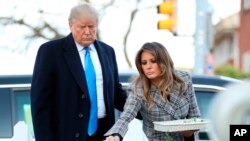 President Donald Trump and his wife Melania Trump place stones at a memorial outside for those killed at the Pittsburgh's Tree of Life Synagogue in Pittsburgh, Tuesday, Oct. 30, 2018. (AP Photo/Andrew Harnik)